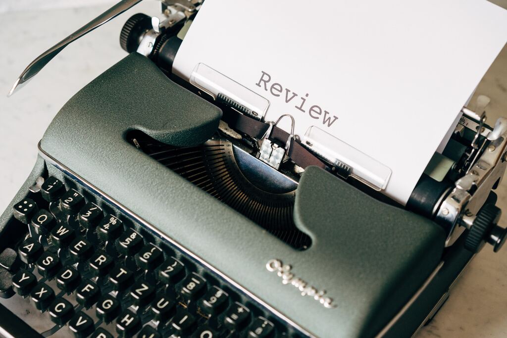Vintage typewriter typing 'Review' on paper, representing KeyBuzz Digital’s expertise in review response and reputation marketing.