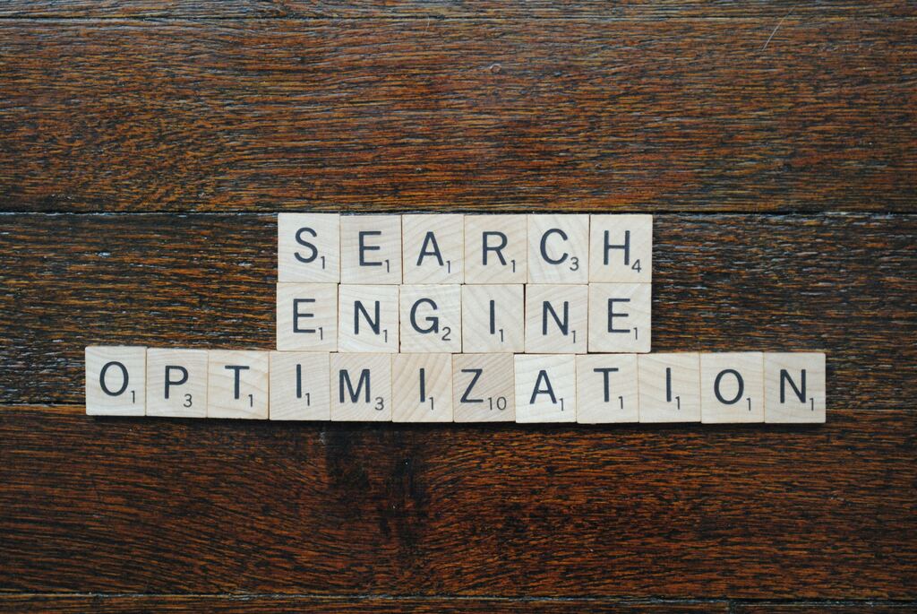Search Engine Optimization spelled out with Scrabble tiles on a wooden table, symbolizing KeyBuzz Digital’s clear and strategic approach to SEO for business growth.