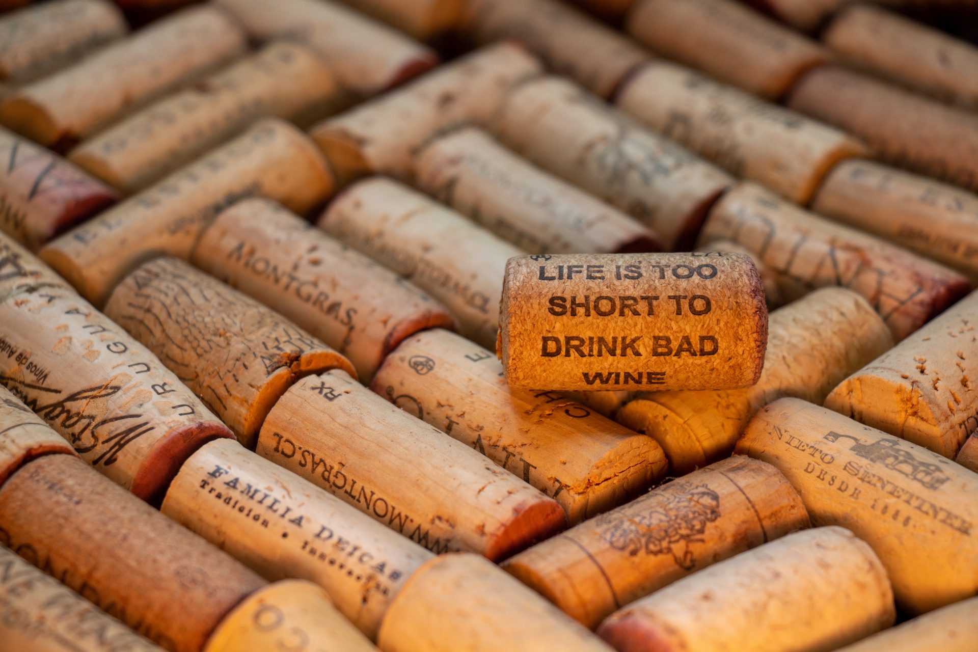 Collection of wine corks with standout cork engraved life is too short to drink bad winesymbolizing the importance of quality experiences whether in wine hospitality or marketing   keybuzz digital marketing services