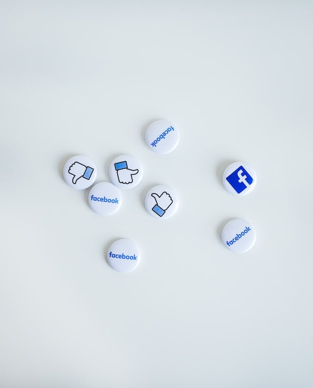 Facebook-themed buttons with thumbs up, thumbs down, and logo icons on white background.
