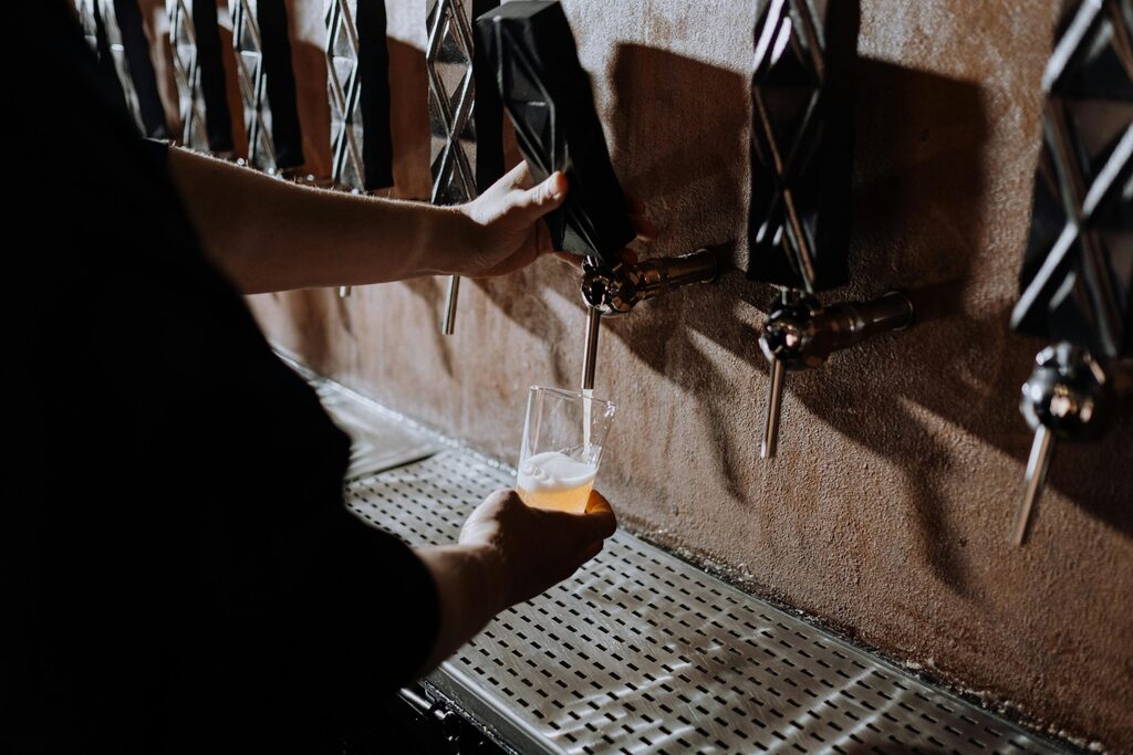 Craft beer being poured from tap into glass, symbolizing small business hospitality and customer experience growth