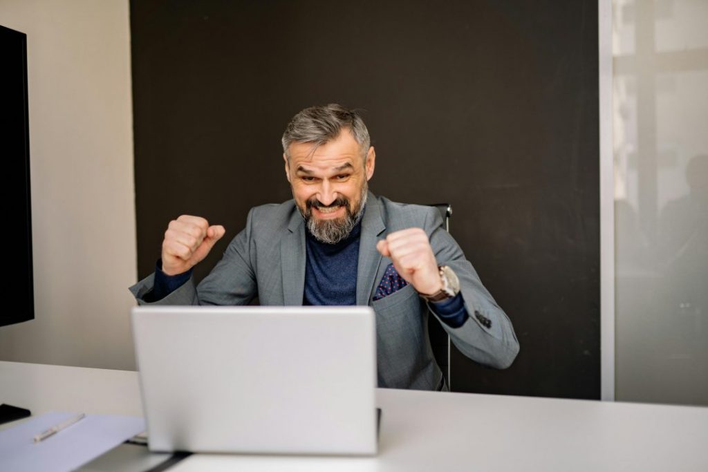 Entrepreneur analyzing performance data from a well-optimized website with charts showing traffic growth and conversions.